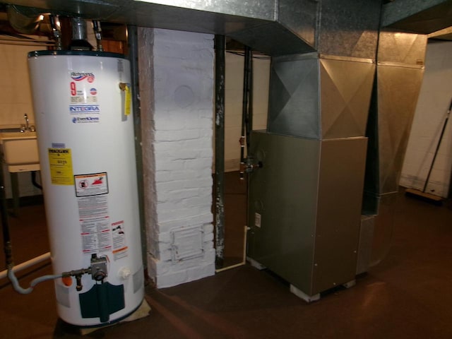 utility room featuring sink, heating unit, and water heater