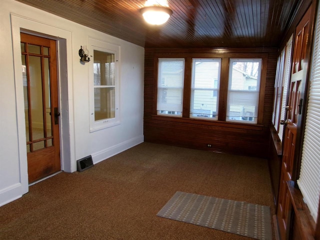 unfurnished sunroom with wooden ceiling