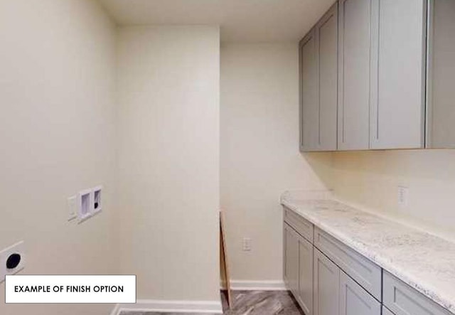 laundry area featuring washer hookup and cabinets