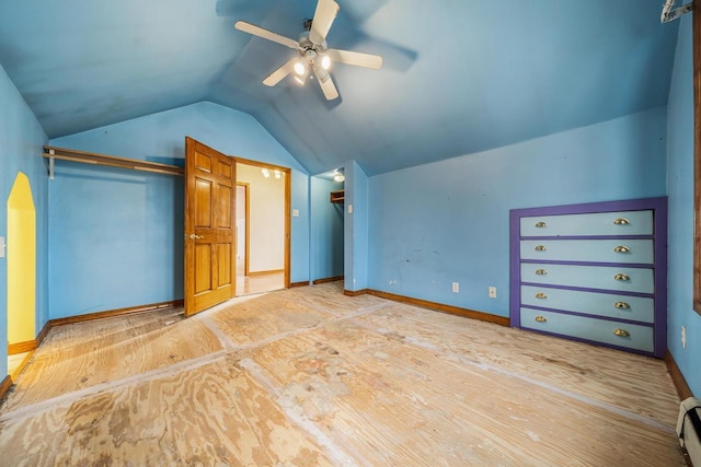 unfurnished bedroom with vaulted ceiling, ceiling fan, a baseboard heating unit, and light hardwood / wood-style flooring