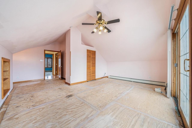 additional living space featuring ceiling fan, a baseboard radiator, and vaulted ceiling