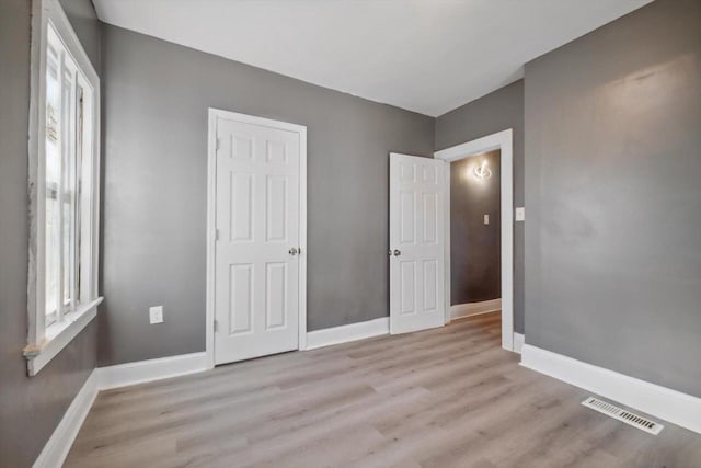 unfurnished bedroom with light wood-type flooring