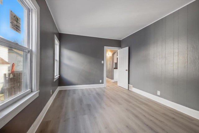 unfurnished room featuring a healthy amount of sunlight and light hardwood / wood-style flooring