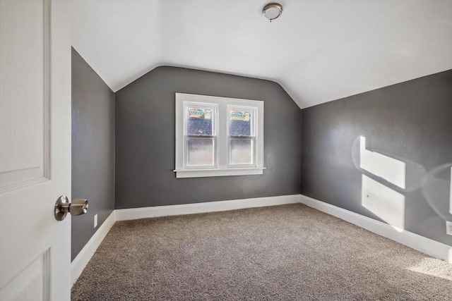 additional living space with lofted ceiling and carpet