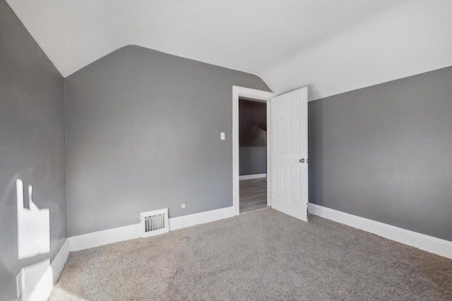 bonus room with lofted ceiling and carpet flooring