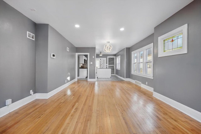 unfurnished living room with light hardwood / wood-style flooring