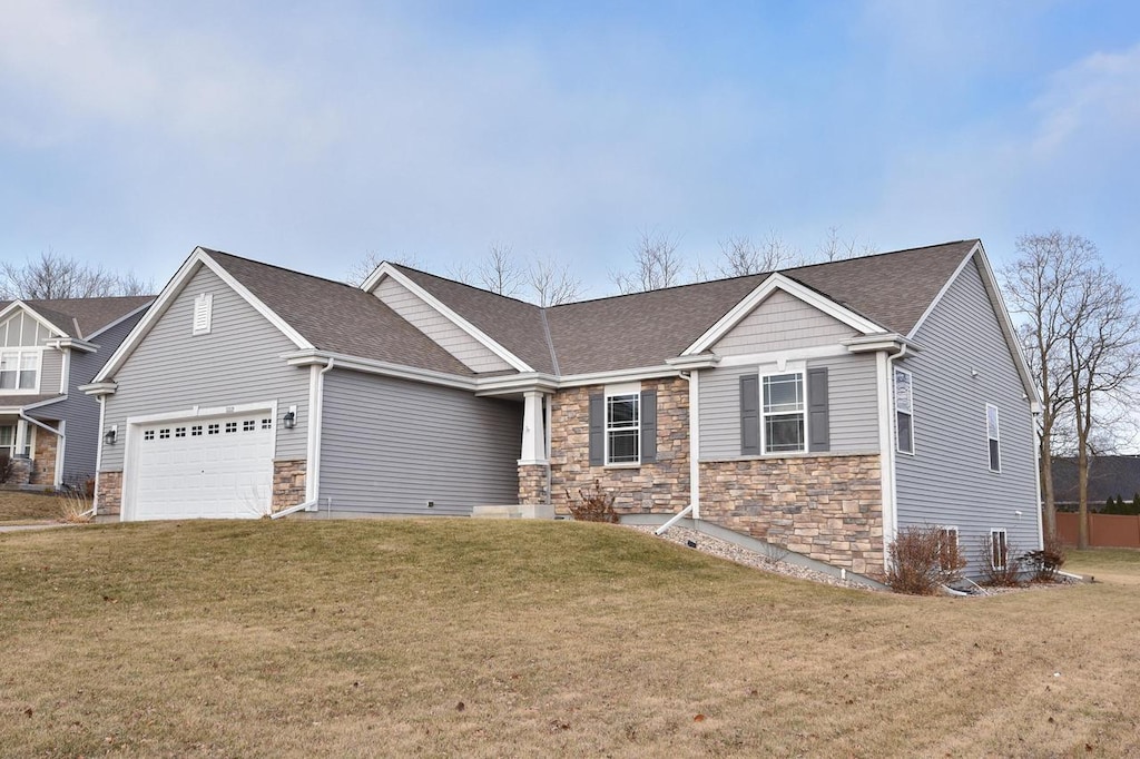 view of front of home featuring a garage and a front yard