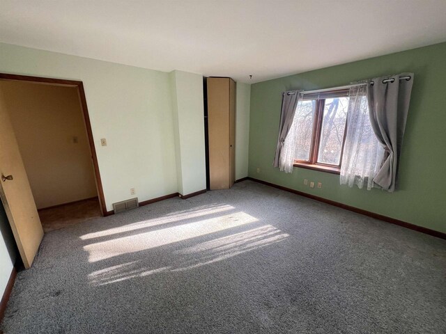 unfurnished bedroom with a closet and carpet flooring