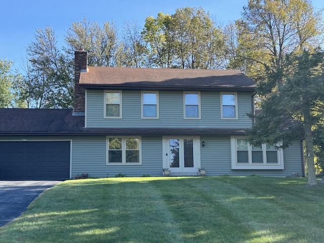 front facade with a front yard and a garage