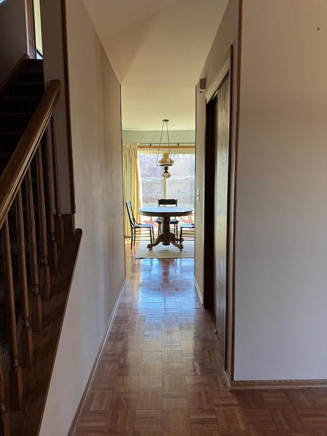 hallway featuring dark parquet flooring