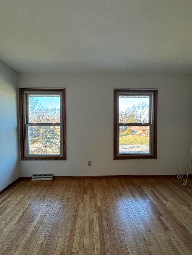 unfurnished room with light hardwood / wood-style floors