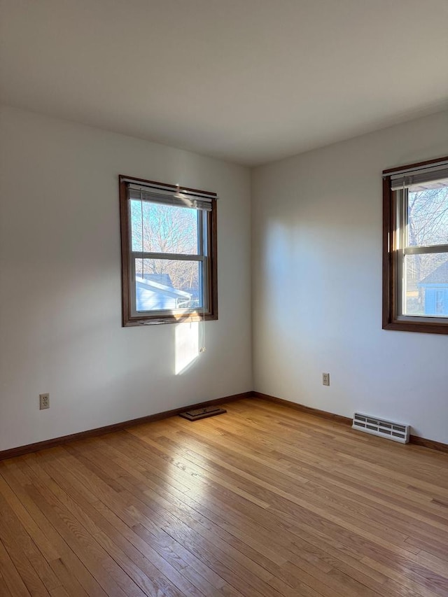 spare room with light hardwood / wood-style floors