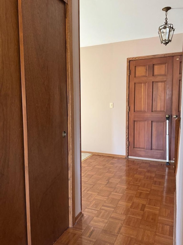 entryway featuring parquet flooring