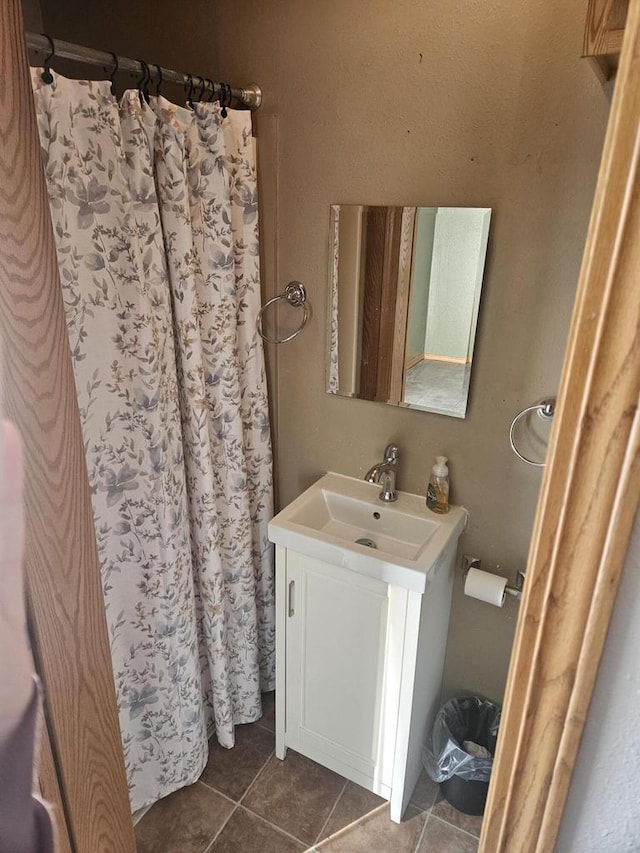 bathroom featuring walk in shower, tile patterned floors, and vanity