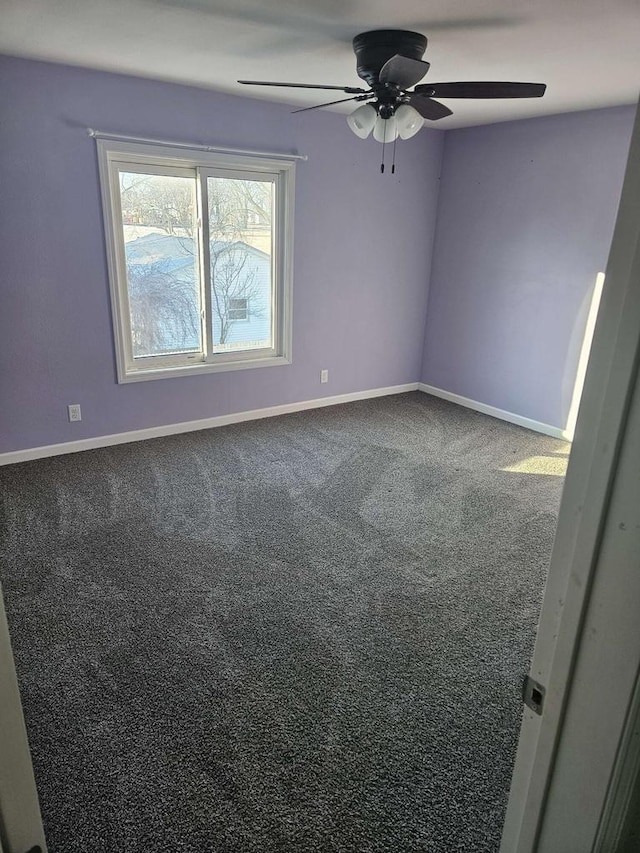 unfurnished room with ceiling fan and carpet flooring