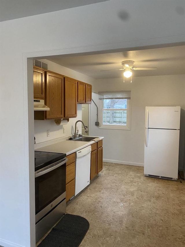 kitchen featuring ceiling fan, white appliances, and sink