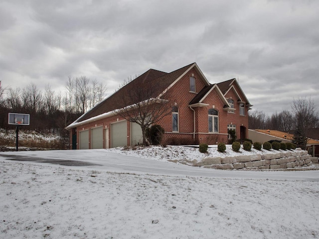 view of snow covered exterior with a garage