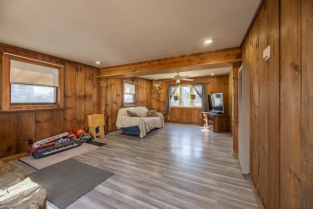 unfurnished bedroom featuring light wood-style floors and wood walls