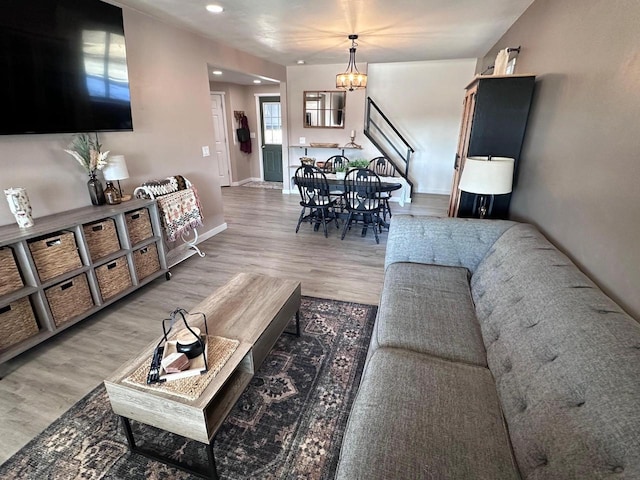 living room with an inviting chandelier and wood-type flooring