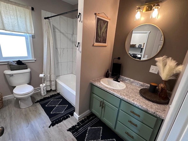 full bathroom with toilet, shower / bath combination with curtain, hardwood / wood-style flooring, and vanity