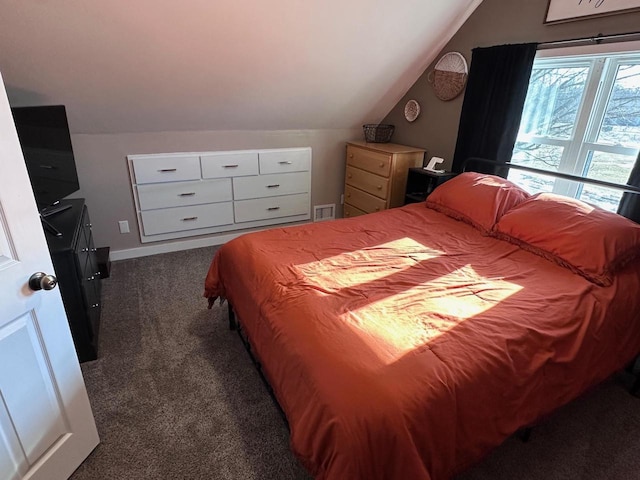 carpeted bedroom featuring lofted ceiling