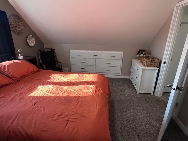 bedroom with vaulted ceiling and dark carpet