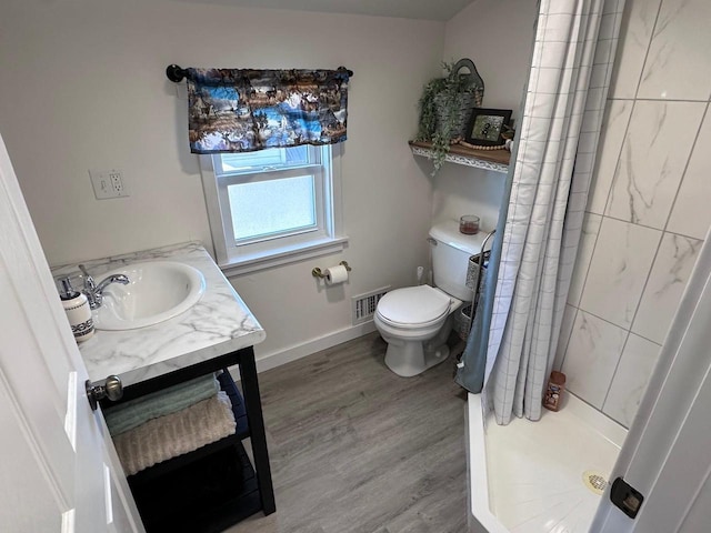 bathroom featuring toilet, a shower with curtain, wood-type flooring, and vanity