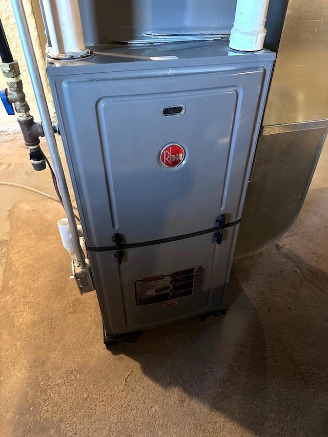 utility room featuring heating unit