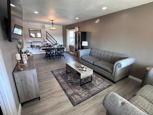 living room with an inviting chandelier and light hardwood / wood-style floors