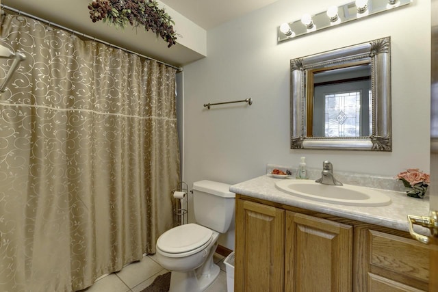 bathroom with vanity, toilet, curtained shower, and tile patterned flooring