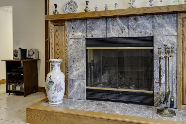 interior details with baseboards and a fireplace