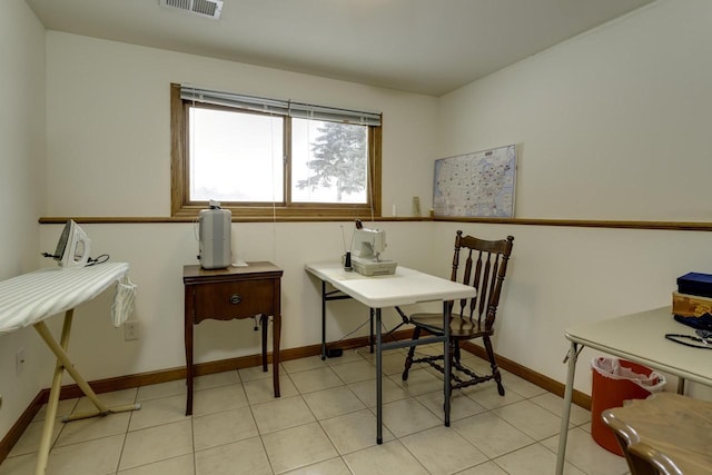 office space featuring light tile patterned floors, visible vents, and baseboards