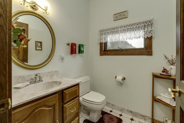 bathroom featuring vanity, tile patterned floors, and toilet