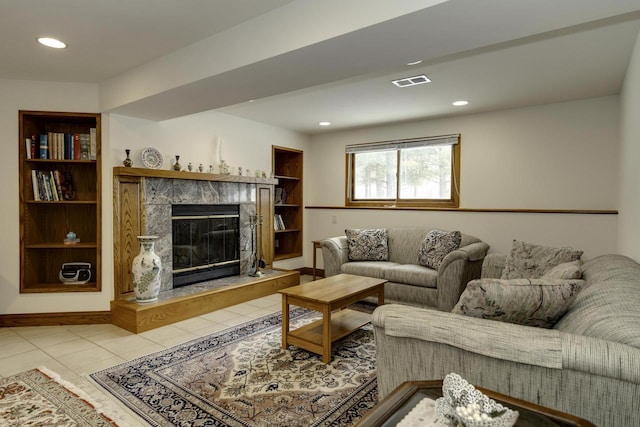 tiled living room with a premium fireplace and built in shelves