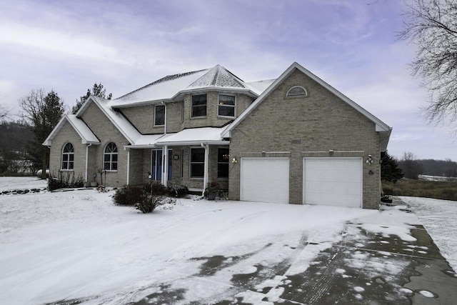 traditional-style home with a garage and brick siding