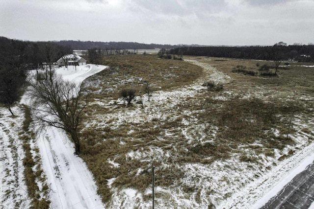 snowy aerial view featuring a rural view