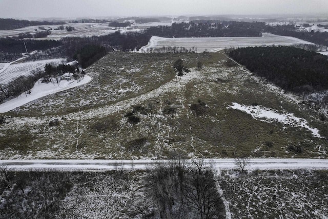 snowy aerial view featuring a rural view