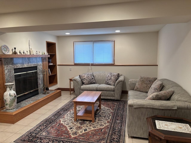 living area featuring light tile patterned floors, a premium fireplace, baseboards, and recessed lighting