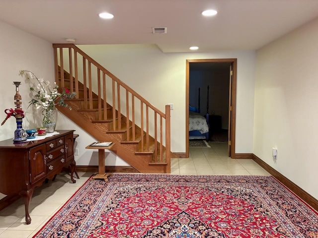 staircase with recessed lighting, visible vents, baseboards, and tile patterned floors