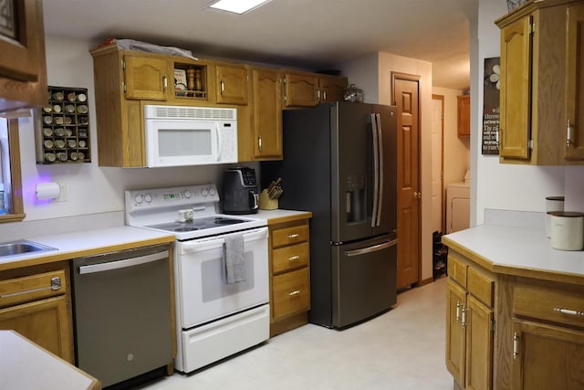 kitchen with washer / clothes dryer and appliances with stainless steel finishes