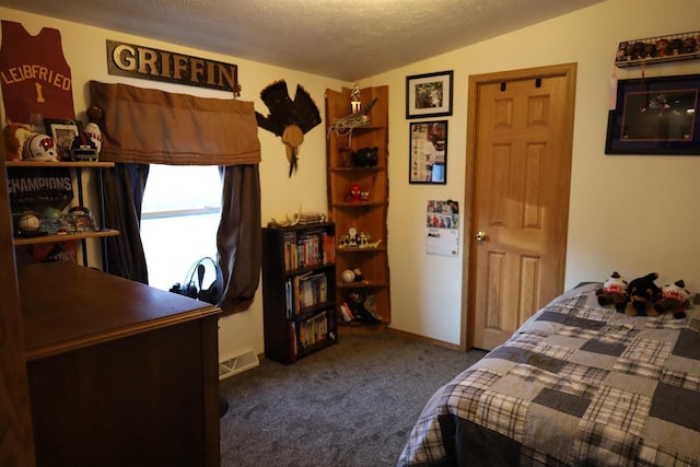 carpeted bedroom featuring a textured ceiling and vaulted ceiling