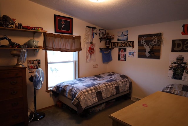 bedroom with a textured ceiling, carpet floors, and vaulted ceiling