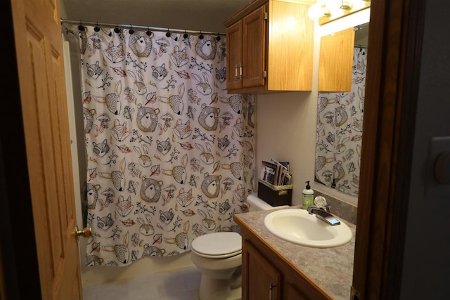 bathroom with curtained shower, toilet, vanity, and tile patterned flooring