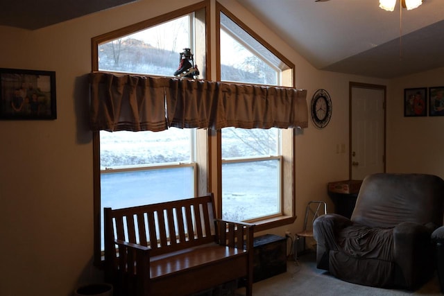 living area featuring lofted ceiling and carpet flooring