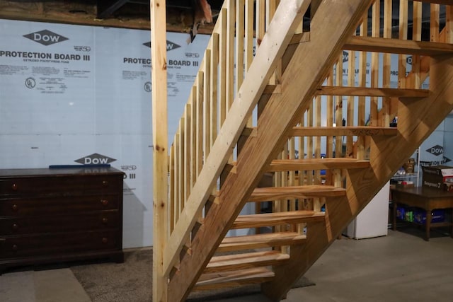 staircase with concrete flooring