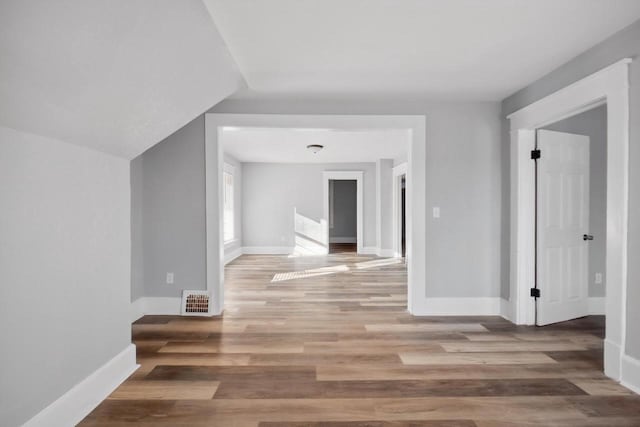 hallway with hardwood / wood-style flooring