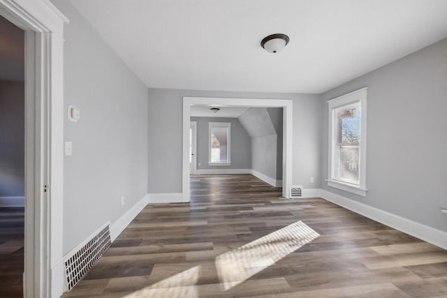 additional living space featuring dark wood-type flooring