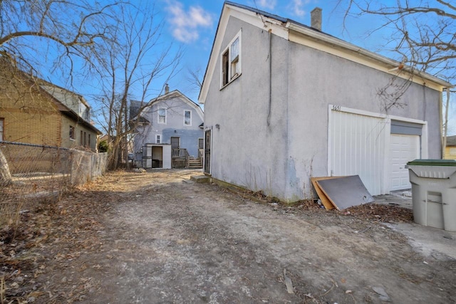 view of side of home featuring a garage