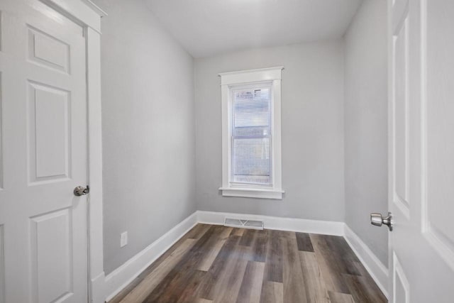 unfurnished room with dark hardwood / wood-style floors