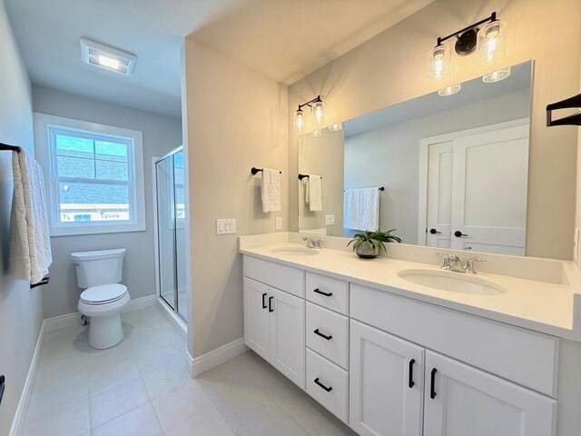 full bathroom with toilet, a stall shower, double vanity, and a sink